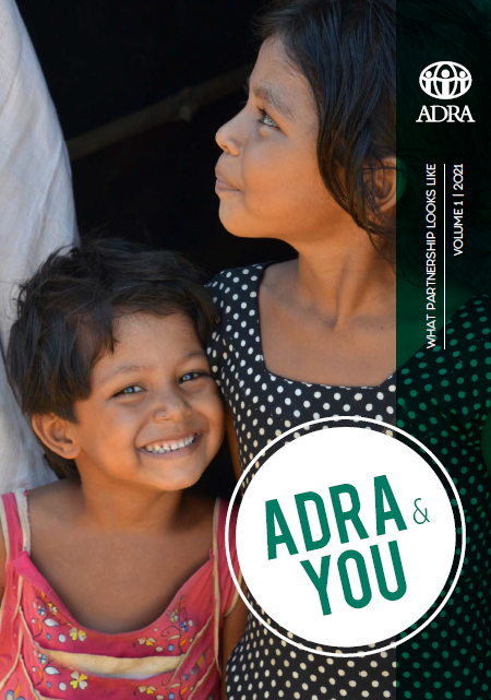 ADRA & You Newsletter Cover: Two young children similing from inside a Rohingya Refugee Camp in Bangladesh